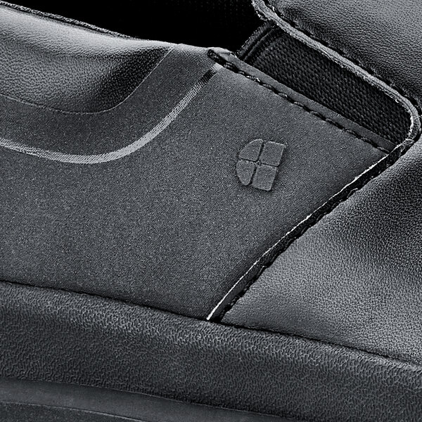 A close up of a black Shoes For Crews Mason men's shoe.