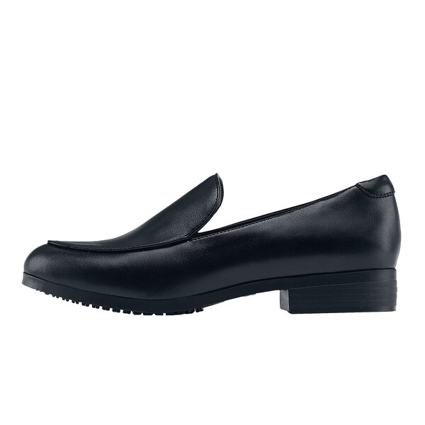 A black loafer with a rubber sole and a pointed toe.