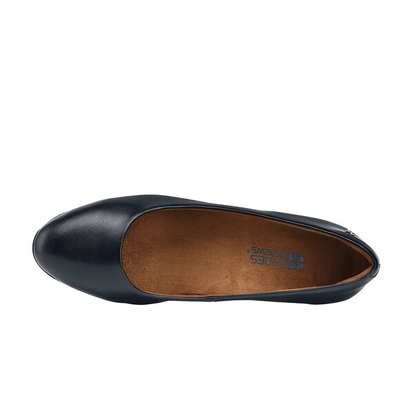 A black leather flat shoe with brown soles.