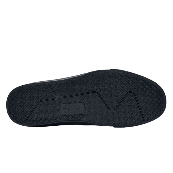 The red sole of a Shoes For Crews Ollie II men's shoe.