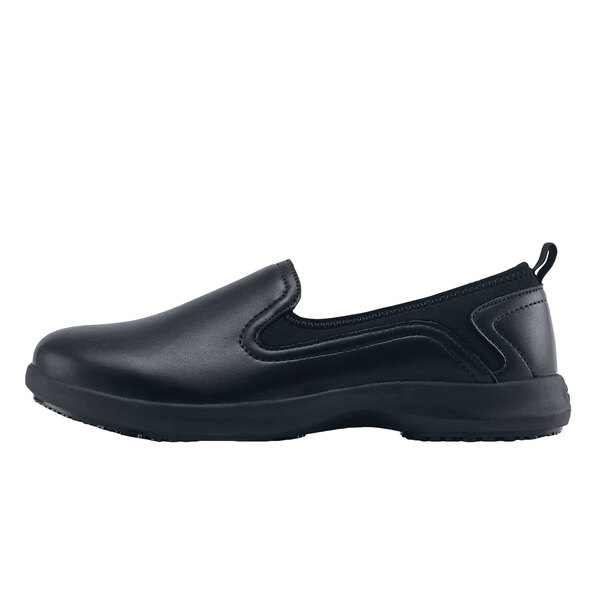 A black Shoes For Crews slip-on shoe with a rubber sole.