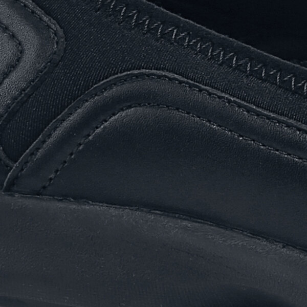 A black Shoes For Crews Quincy casual shoe with a zipper on the side.