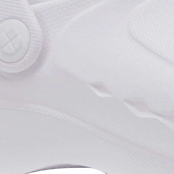 The white Shoes for Crews shoe with a black sole.