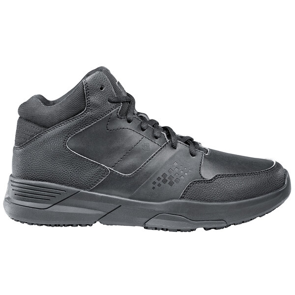 A pair of black Shoes For Crews men's athletic shoes on a table.