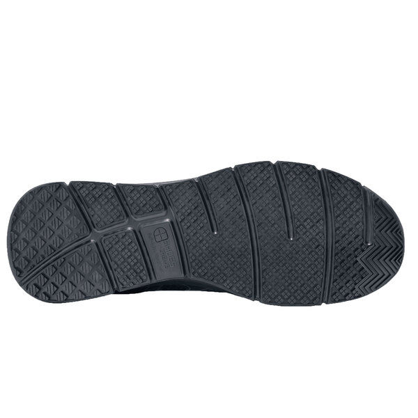 The black rubber sole of a Stride men's shoe.