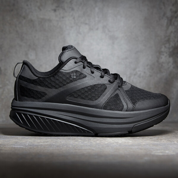 A close up of a black Shoes For Crews Energy II women's athletic shoe.