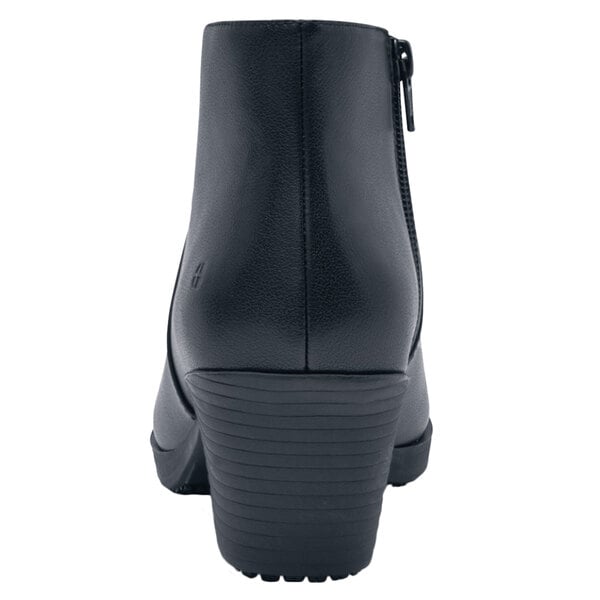 A black Shoes For Crews Delilah dress shoe with a zipper on the side.