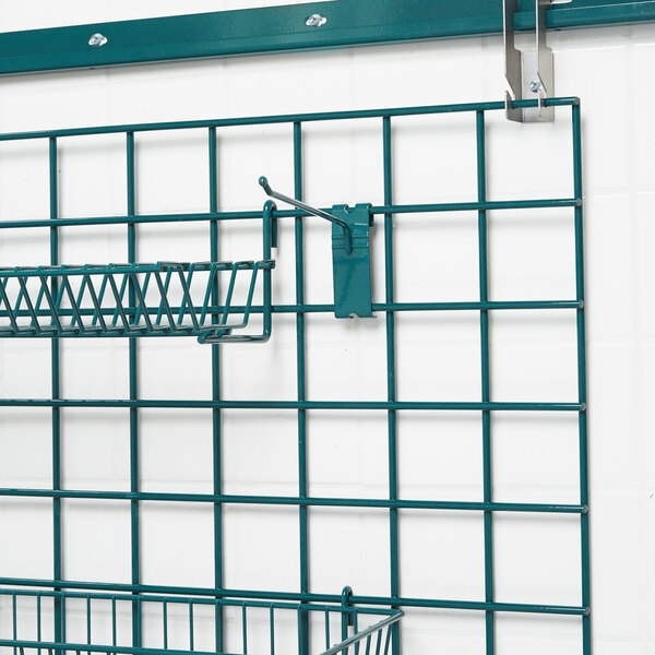 A Metroseal 3 wire grid with a basket and a hook on it.