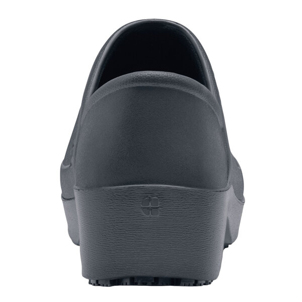 A close-up of a black Shoes For Crews women's non-slip shoe with a black sole.