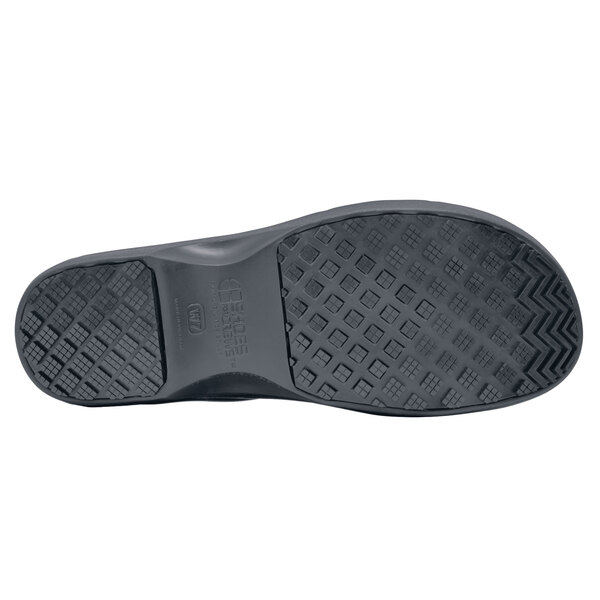 A black Shoes For Crews women's shoe with a black sole.
