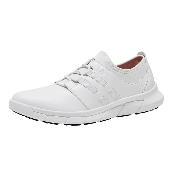 A white Shoes For Crews women's athletic shoe with laces.