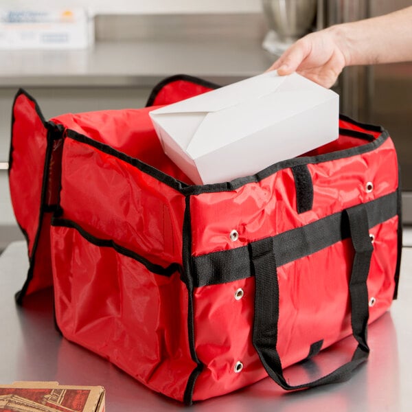 A red bag with a white box in it.