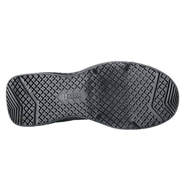 The sole of a black Shoes For Crews Energy II athletic shoe.