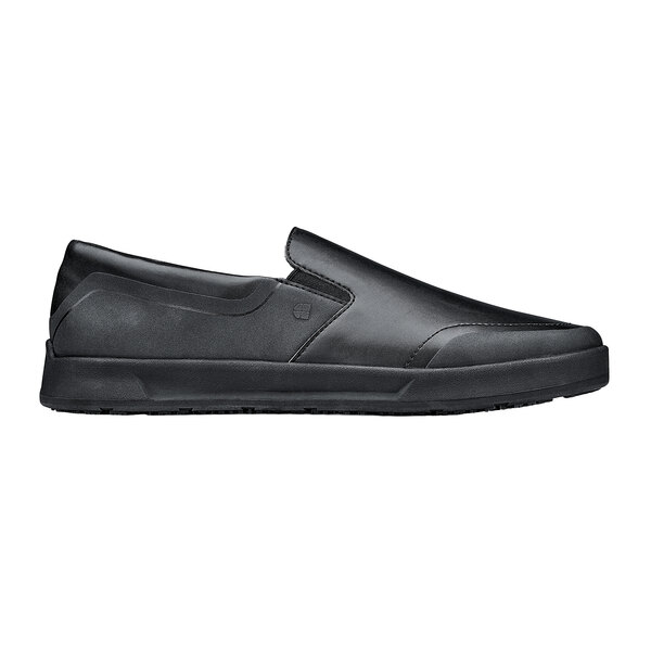A black Shoes for Crews slip-on shoe with a rubber sole.