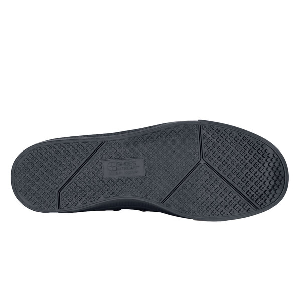 A black Shoes For Crews casual shoe with a black rubber sole.