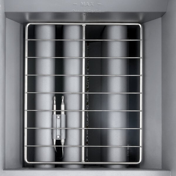 A stainless steel liquid propane floor fryer with a 40 lb. oil capacity and protective wire basket.