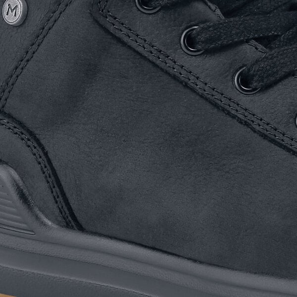 A MOZO black leather men's shoe with a rubber sole on a table.