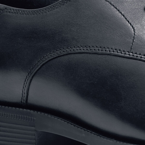 A close-up of a black Shoes For Crews Senator dress shoe.