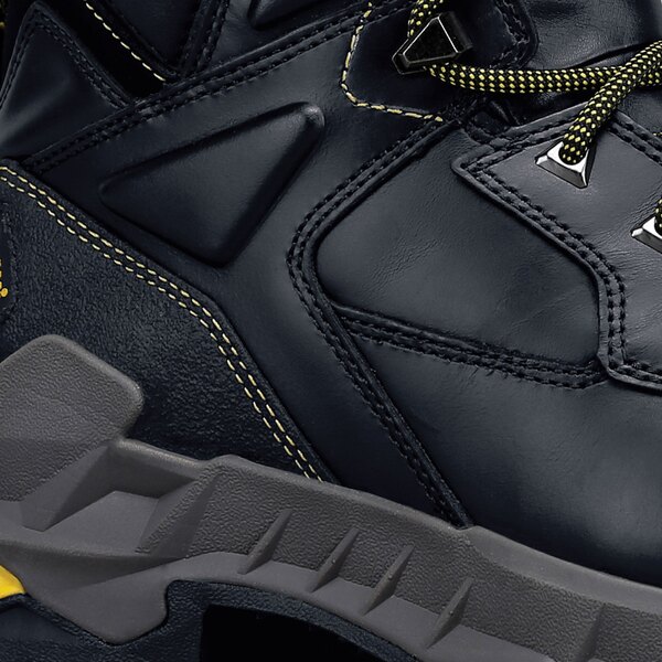 A close-up of a black ACE Burren work boot with yellow accents.
