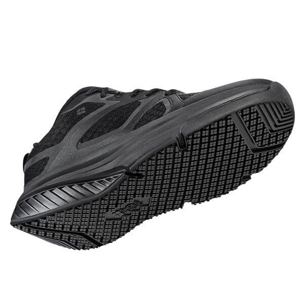 A black Shoes For Crews Energy II women's athletic shoe with a sole.