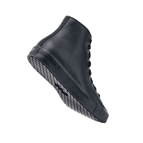 Shoes For Crews black casual shoe on a table with a sole.