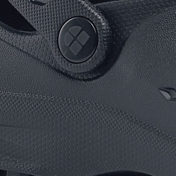 A close up of a black sole on a Shoes For Crews shoe.