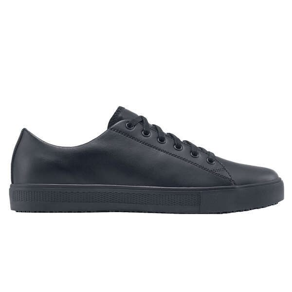 A black leather Shoes For Crews low rider shoe with laces and a rubber sole.