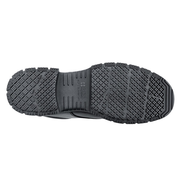 A close-up of a black Shoes For Crews Cade work boot with a black sole.