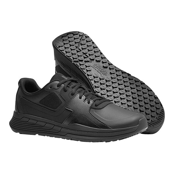A pair of black Shoes For Crews Falcon III athletic shoes with a rubber sole.