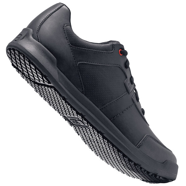 a black shoe with a white background