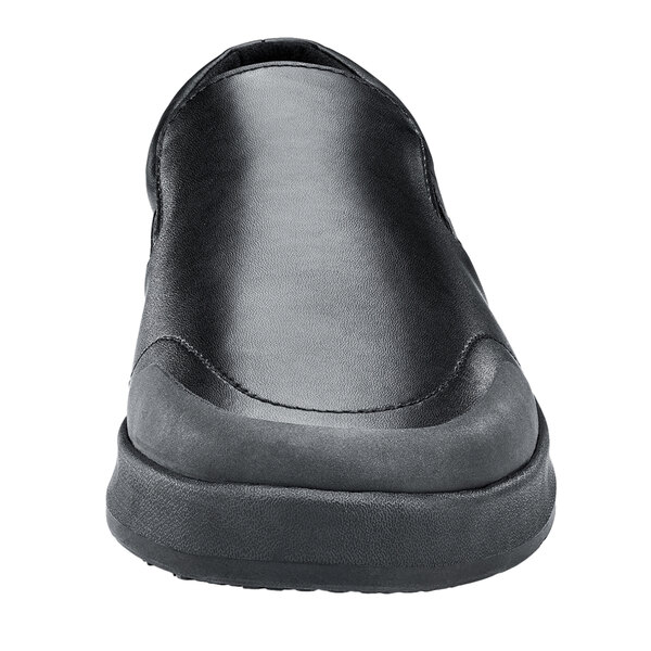 A close up of a black Shoes For Crews Mason men's slip-on shoe with a rubber sole.