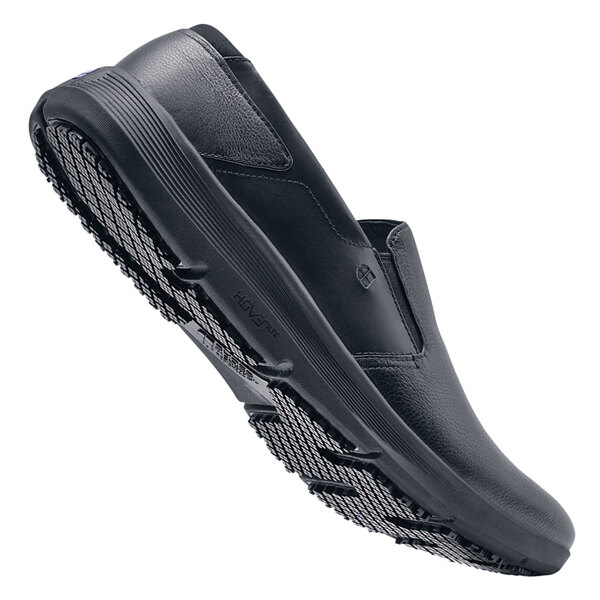 A pair of black Shoes For Crews slip-on shoes for men with rubber soles.