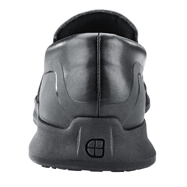 A black Shoes For Crews slip-on shoe with a rubber sole.