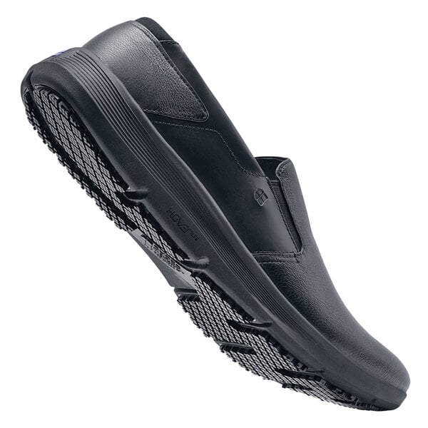 A pair of men's black slip-on Shoes For Crews with rubber soles.