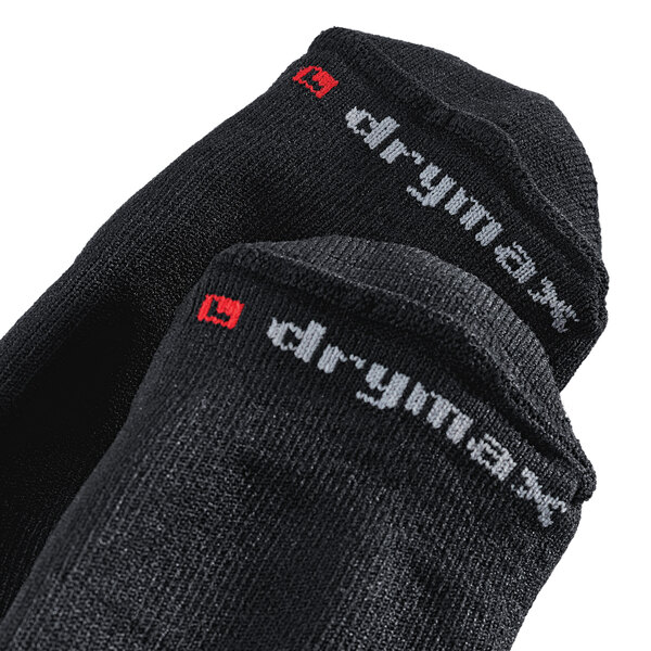 A pair of black Shoes For Crews no-show socks with white text on the sole.