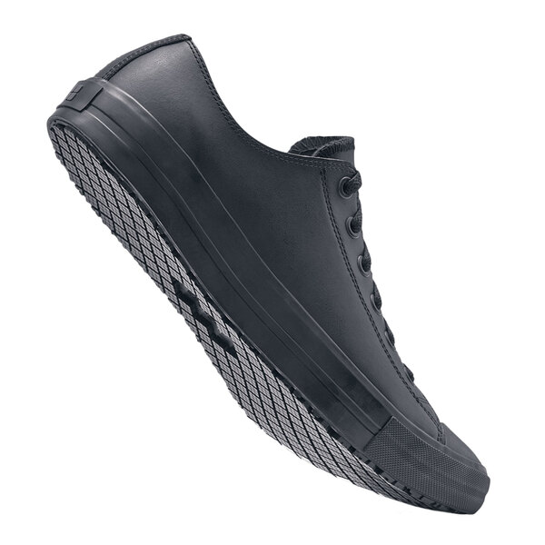 A black Shoes For Crews Delray women's shoe with a sole.