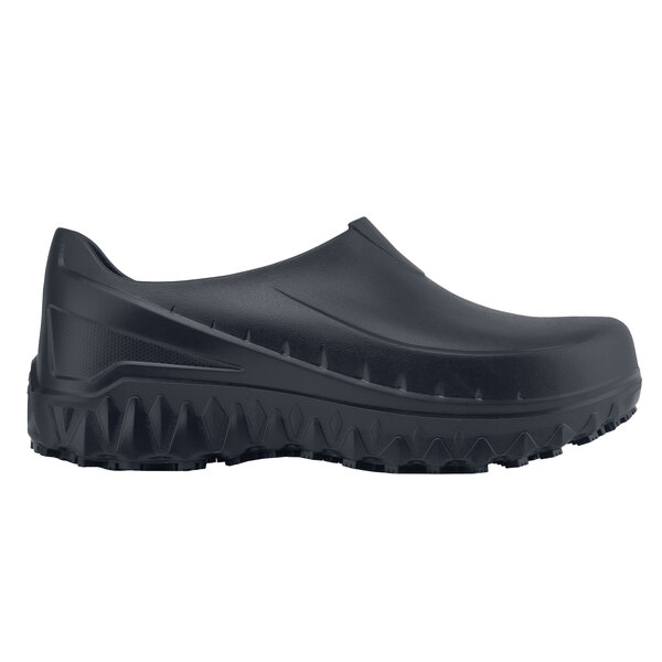 A black Shoes For Crews men's work shoe with rubber soles.