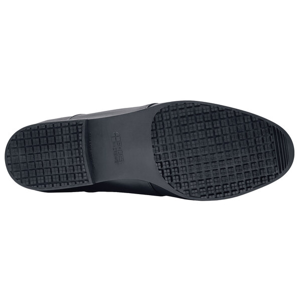 A black Shoes For Crews Madison III dress shoe with a rubber sole.