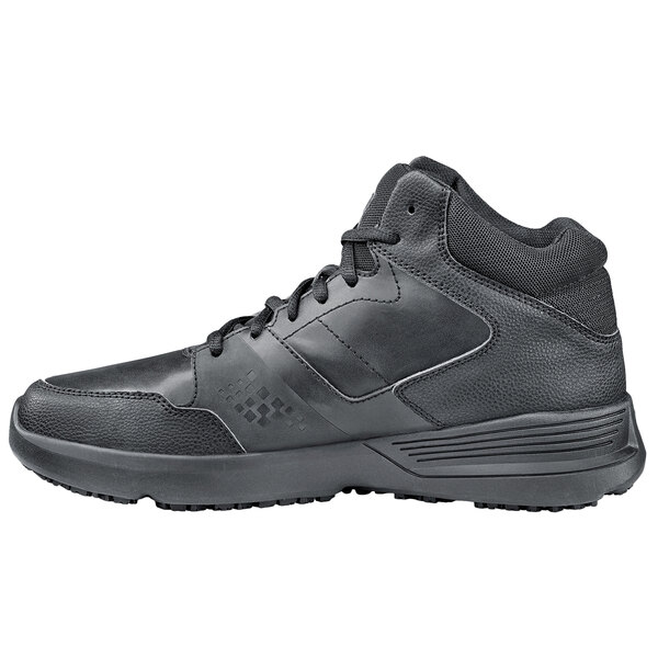 A black Shoes For Crews Hart men's athletic shoe with laces.