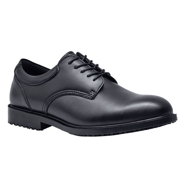 A black Shoes For Crews Cambridge dress shoe with laces.