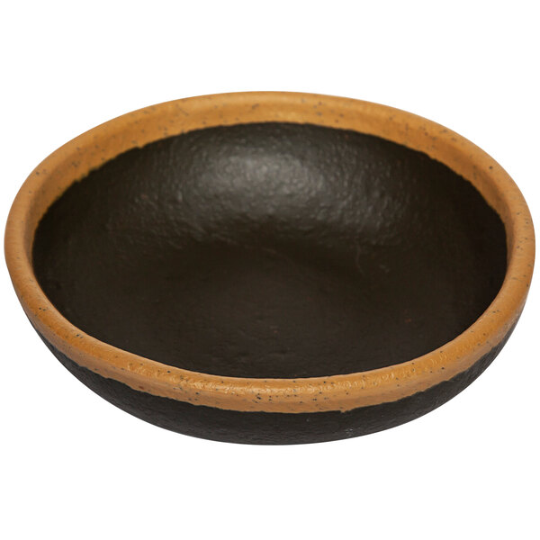A brown bowl with a black and brown clay trim.