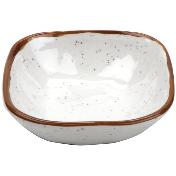 A white melamine bowl with brown speckled edges.