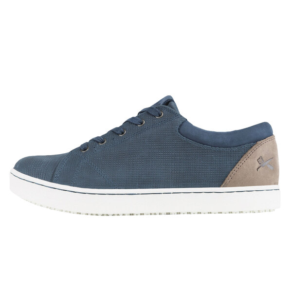 A close-up of MOZO Mavi women's blue and taupe casual shoes with a leather upper and rubber sole.