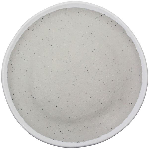 A white plate with black speckled spots.