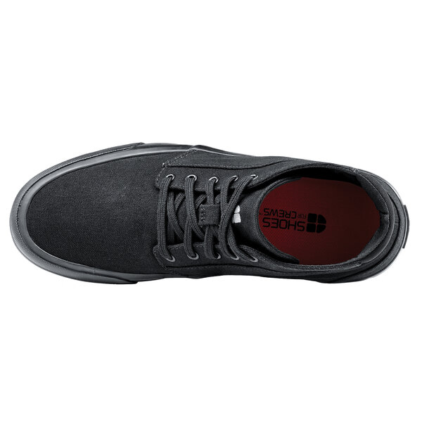 A black Shoes For Crews Cabbie II shoe with a red sole.