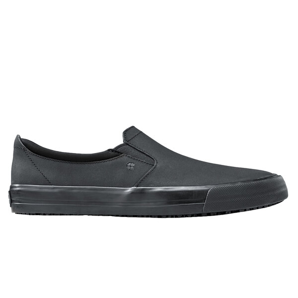 A black slip on Shoes For Crews shoe with a rubber sole.