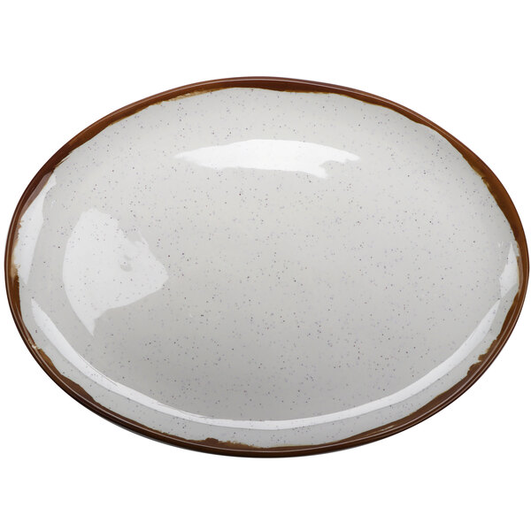 A white oval melamine platter with brown speckled edges.