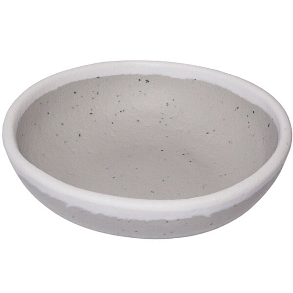A white ramekin with grey speckles.