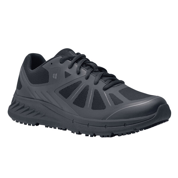 A black Shoes For Crews athletic shoe for men with a white background.