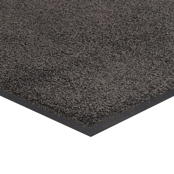 A gray rubber-backed carpet mat with a black border.